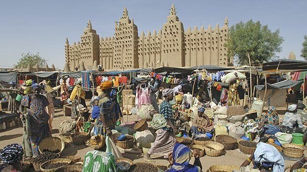 Market in front of the Great Mosque in Djenne - the largest mud structure in the world